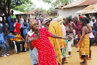 A woman from the village of Galai, Liberia, celebrates following a dramatic presentation on the country's new laws.