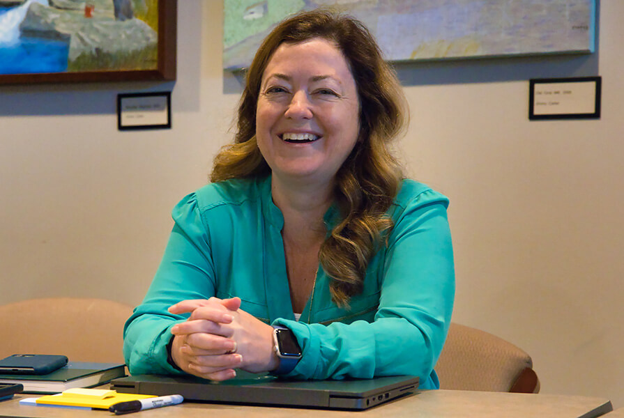 Barbara Smith sits at a table.