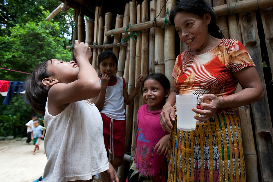 A little girl in Guatemala takes a dose of Mectizan.