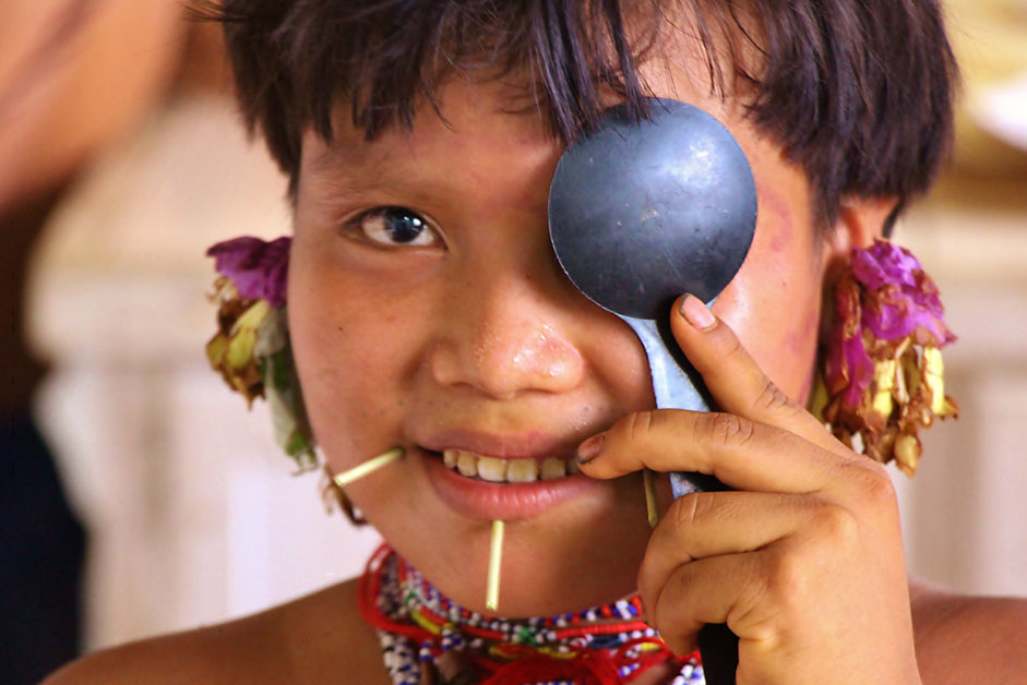 A Yanomami girl in Brazil takes a vision test. 
