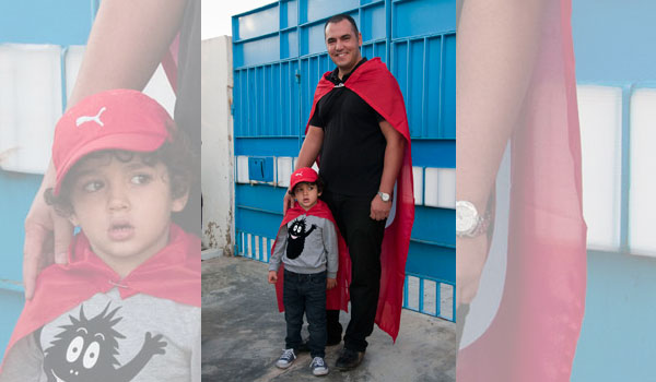 This man brought his young son to watch him vote, both enthusiastically draped in a Tunisia flag cape.