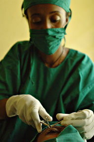 Photo of a surgeon performing eyelid surgery on a patient with trichiasis, or advanced trachoma.